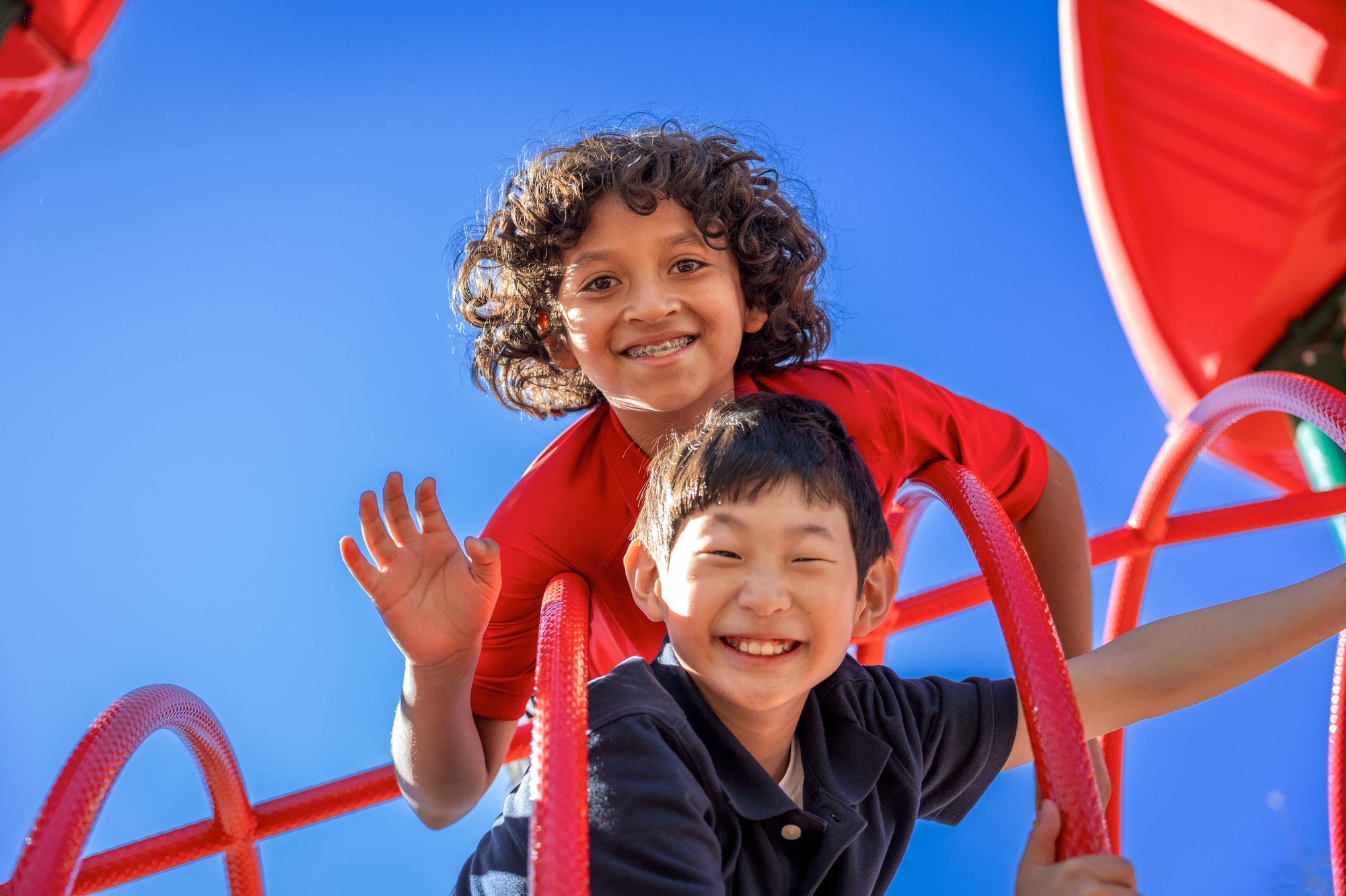 SHJ Students smiling together in a playground